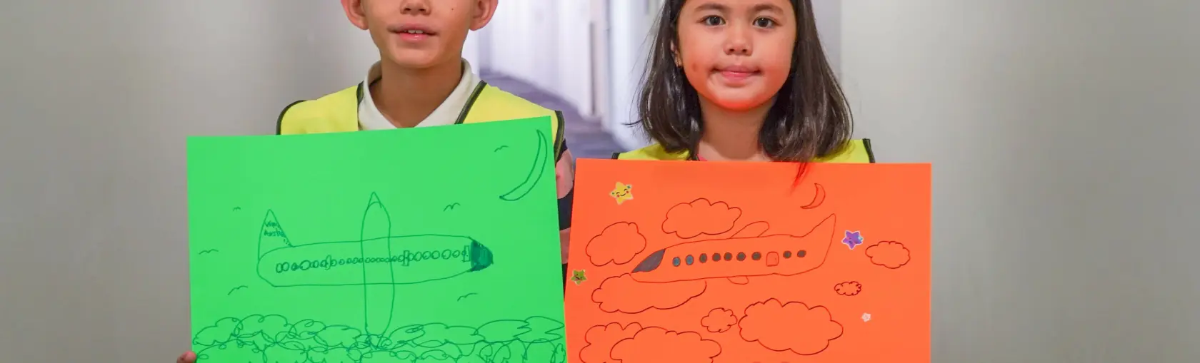 Boy and girl holding posters