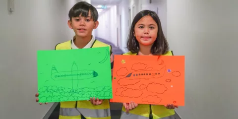 Boy and girl holding posters