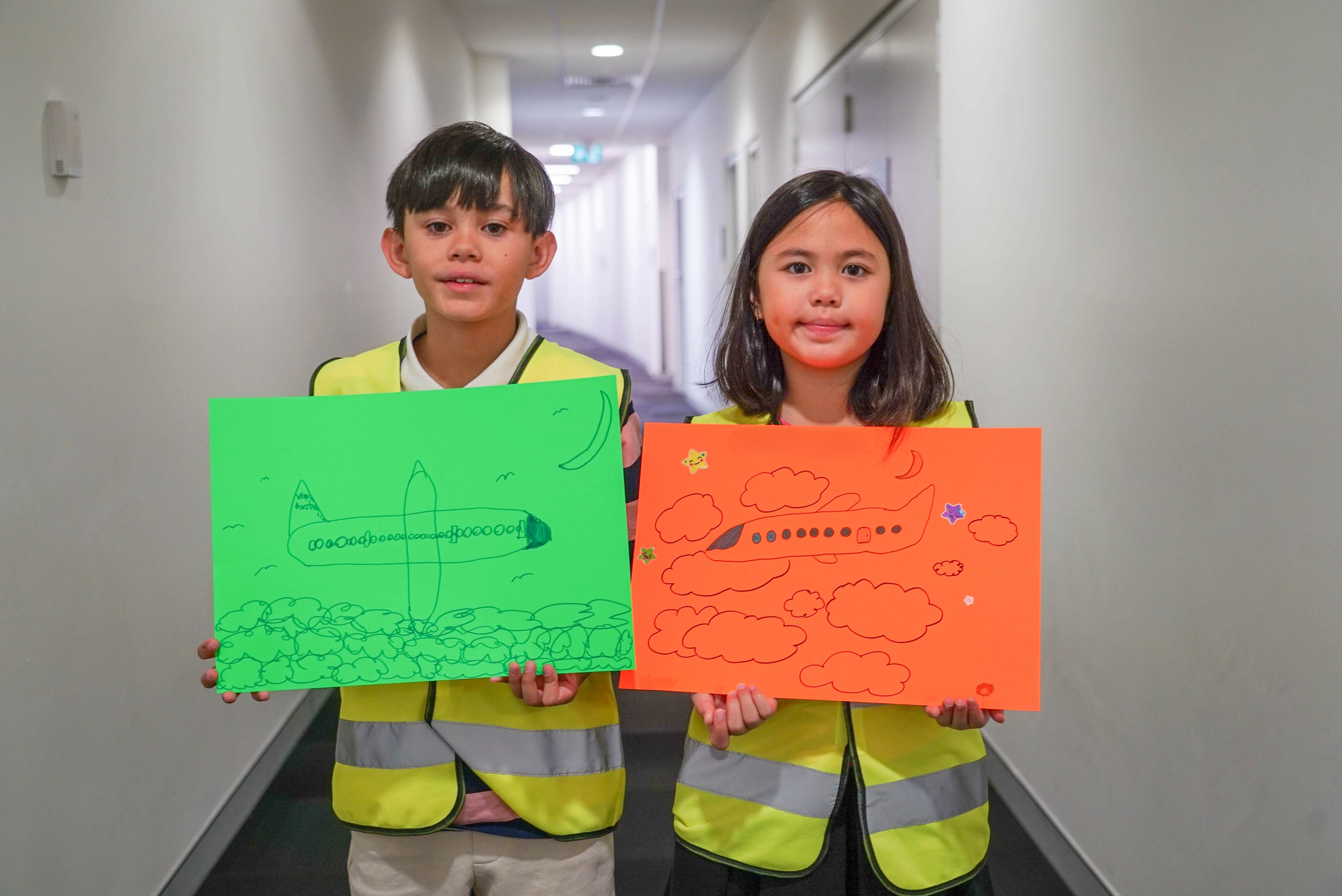 Boy and girl holding posters